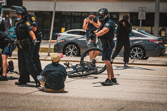 A Tampa police officer aims pepper spray at a Black Lives Matte protester in Tampa, Florida on July 4, 2020. - Photo by Chander Culotta